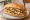 Torta de Chilaquiles: an illustration of salsa, egg, chicken, refried beans and more on bread.