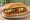 Torta de Chorizo: an illustration of chorizo, vinegar, refried beans, avocado and more on bread.