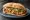 Torta de Chorizo con Huevo: an illustration of chorizo, egg, refried beans, avocado and more on bread.