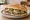 Torta de Frijoles: an illustration of refried beans, cheese, avocado, onion and more on bread.