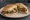 Torta de Hongos: an illustration of mushroom, cheese, onion and refried beans on bread.