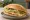 Torta de Huevo: an illustration of egg, refried beans, avocado, onion and more on bread.