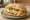 Torta de Huevo con Jamón: an illustration of ham, egg, refried beans, avocado and more on bread.