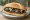 Torta de Huitlacoche: an illustration of corn, onion, cheese and refried beans on bread.
