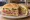Torta de Jamón: an illustration of ham, refried beans, sour cream, lettuce and more on bread.