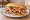 Torta de la Barda: an illustration of pork, ham, sausage, cheese and more on bread.