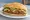 Torta de Milanesa: an illustration of beef, chicken, egg, refried beans and more on telera roll.