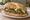 Torta de Nopales: an illustration of cheese, onion, refried beans and avocado on bread.
