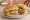 Torta de Pollo: an illustration of chicken, refried beans, sour cream, avocado and more on bread.