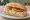 Torta de Pollo Desmenuzado: an illustration of chicken, mayonnaise, lime, avocado and more on bread.