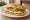 Torta de Queso: an illustration of queso fresco, refried beans, avocado, lettuce and more on bread.