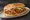 Torta de Tinga: an illustration of chicken, tomato, onion, beans and more on bread.