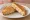 Tost z Kurczakiem: an illustration of chicken and cheese.