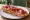 Tostada con Jamón: an illustration of jamón and olive oil on baguette.