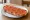 Tostada con Tomate: an illustration of tomato, olive oil and garlic on baguette.