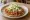 Tostada de Tinga: an illustration of chicken, tomato, onion, beans and more on tortilla.