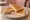 Tostado: an illustration of ham, cheese and butter on white bread.