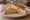 Tostado con Huevo: an illustration of ham, cheese and egg on white bread.