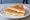 Tostado de Queso: an illustration of cheese on white bread.