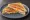 Tostado Especial: an illustration of ham, cheese, egg and tomato on white bread.
