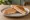 Tostado Mixto: an illustration of ham and cheese on white bread.