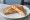 Tosti: an illustration of ham, cheese and butter.