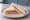 Tramezzino al Salmone: an illustration of salmon, cream cheese, butter, dill and more on white bread.