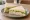 Tramezzino al Tacchino: an illustration of turkey, mayonnaise, lettuce and cheese on white bread.