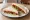 Tramezzino alle Verdure Grigliate: an illustration of eggplant, bell pepper, olive oil, mayonnaise and more on white bread.