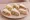 Tramezzino Misto: an illustration of prosciutto, tuna, egg, cheese and more on white bread.