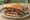 Tri-Tip Sandwich: an illustration of beef, salsa and butter on hoagie roll.