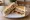 Triple Decker Sandwich: an illustration of butter, cheese, tomato, cucumber and more on white bread.