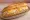 Tuna Grinder: an illustration of tuna, mayonnaise, american cheese and provolone on hoagie roll.
