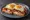 Uitsmijter Compleet: an illustration of ham, bacon, egg, cheese and more.
