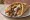 UK Doner/Gyros: an illustration of lamb, beef, onion, tomato and more on pita.