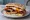 Ulster Fry Sandwich: an illustration of bacon, sausage, egg, tomato and more on burger bun.
