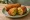 Veg Bread Roll: an illustration of potato, carrot, pepper and cilantro on white bread.