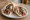 Vegan Souvlaki: an illustration of mock meat, mushroom, tomato and onion on pita.