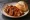 Vegane Currywurst: an illustration of ketchup and curry powder on bread.