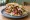 Veganer Döner: an illustration of mock meat, lettuce, tomato, onion and more.