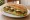 Vejeteryan Sandviç: an illustration of lettuce, tomato, cucumber, cheese and more on bread.