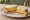 Vintage Cheddar: an illustration of cheddar cheese, butter and quince paste on white bread.
