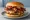 Wendy's Baconator: an illustration of beef, bacon, american cheese, ketchup and more on burger bun.