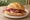 Westfälischer Schinken Brötchen: an illustration of butter on kaiser roll.
