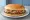 Whataburger Original: an illustration of beef, mustard, lettuce, tomato and more on burger bun.