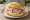 Wurstsalat Brötchen: an illustration of onion, vinegar and olive oil on kaiser roll.