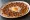 Yumurtalı Lahmacun: an illustration of lamb, egg, onion, tomato and more.