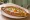 Yumurtalı Pide: an illustration of egg, butter and parsley on pita.