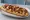 Zapiekanka BBQ: an illustration of pork, chicken, cheese, mushroom and more.