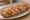 Zapiekanka Hawajska: an illustration of ham, pineapple, mushroom, cheese and more.